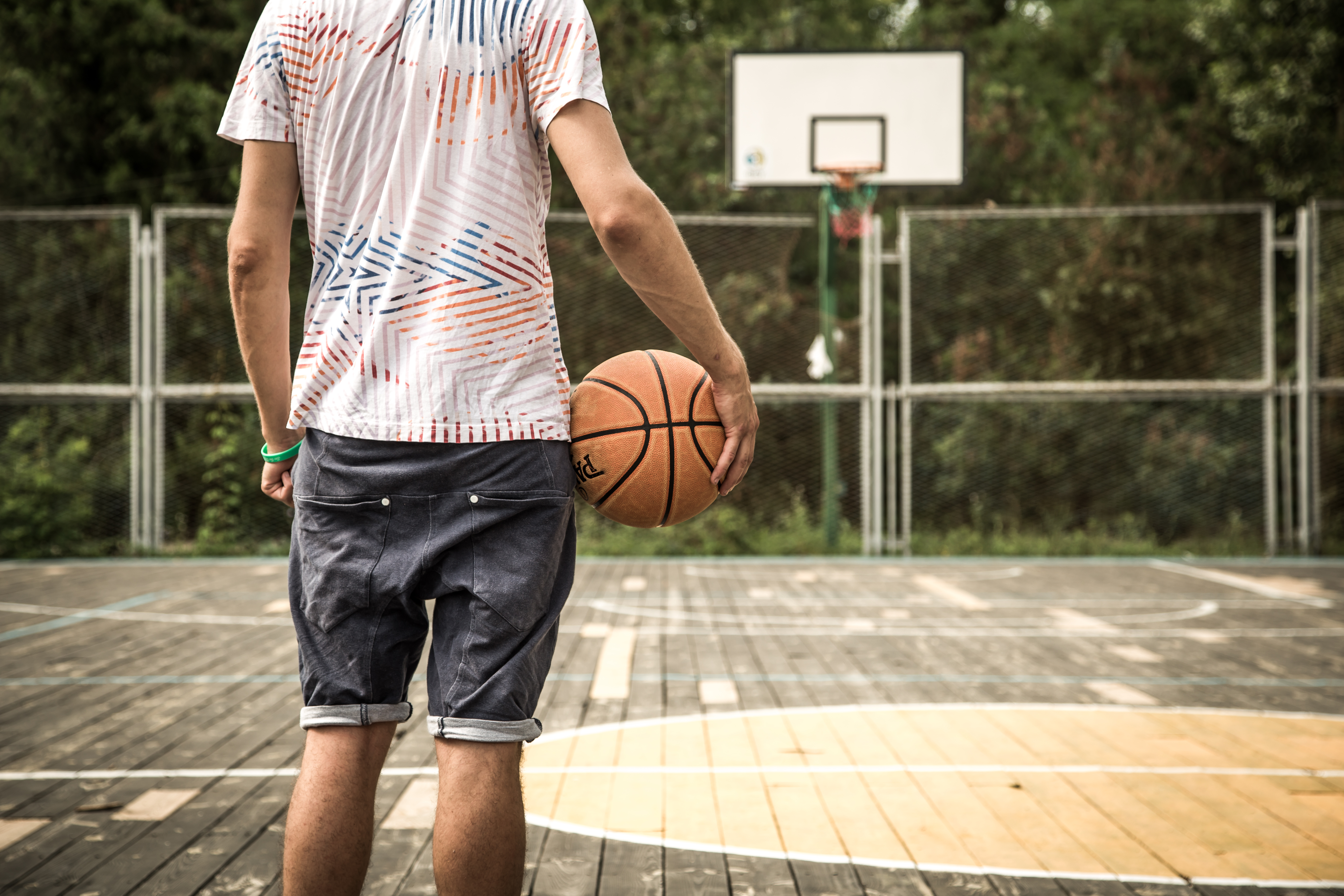 a young man with a basketball on the court
